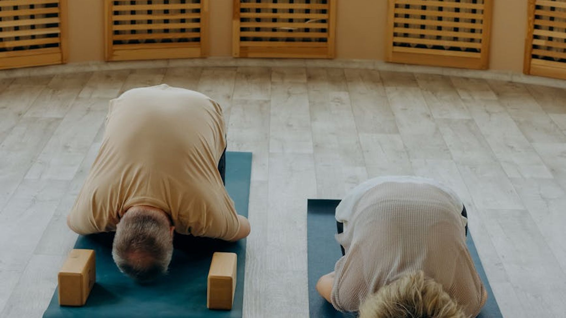 Minimalist yoga studio with soft sunlight and wooden floor.